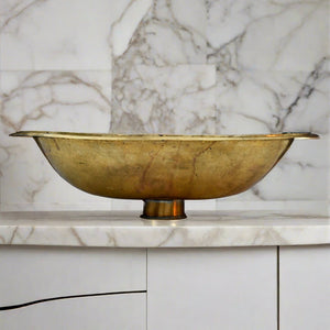 Bottom view of a Moroccan brass drop-in sink on a modern countertop 