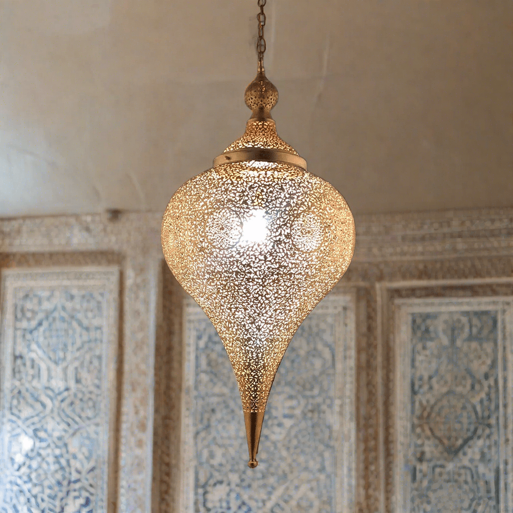 Brass pendant light hanging from the ceiling in an old home in Marrakesh 