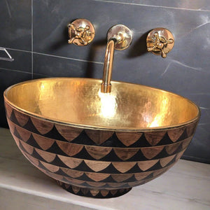 Bathroom interior with brass sink and brass faucet mounted on top