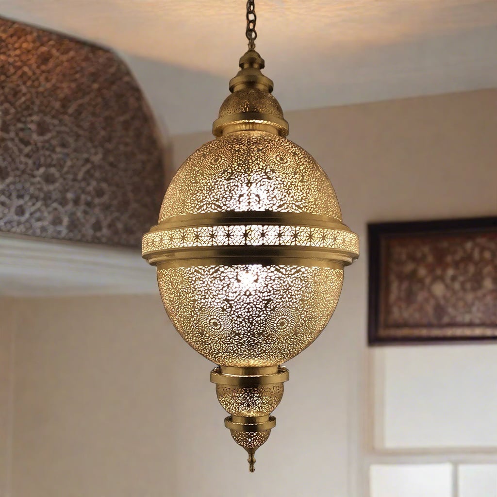 Ornate Moroccan brass lamp hanging from the ceiling in an oriental room with Arabesque patterns