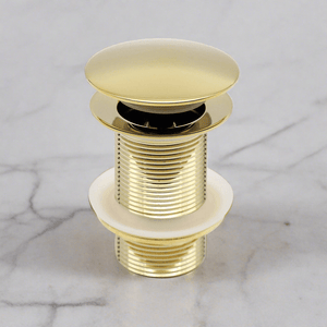 Brass popup drain on top of a white marbel background 