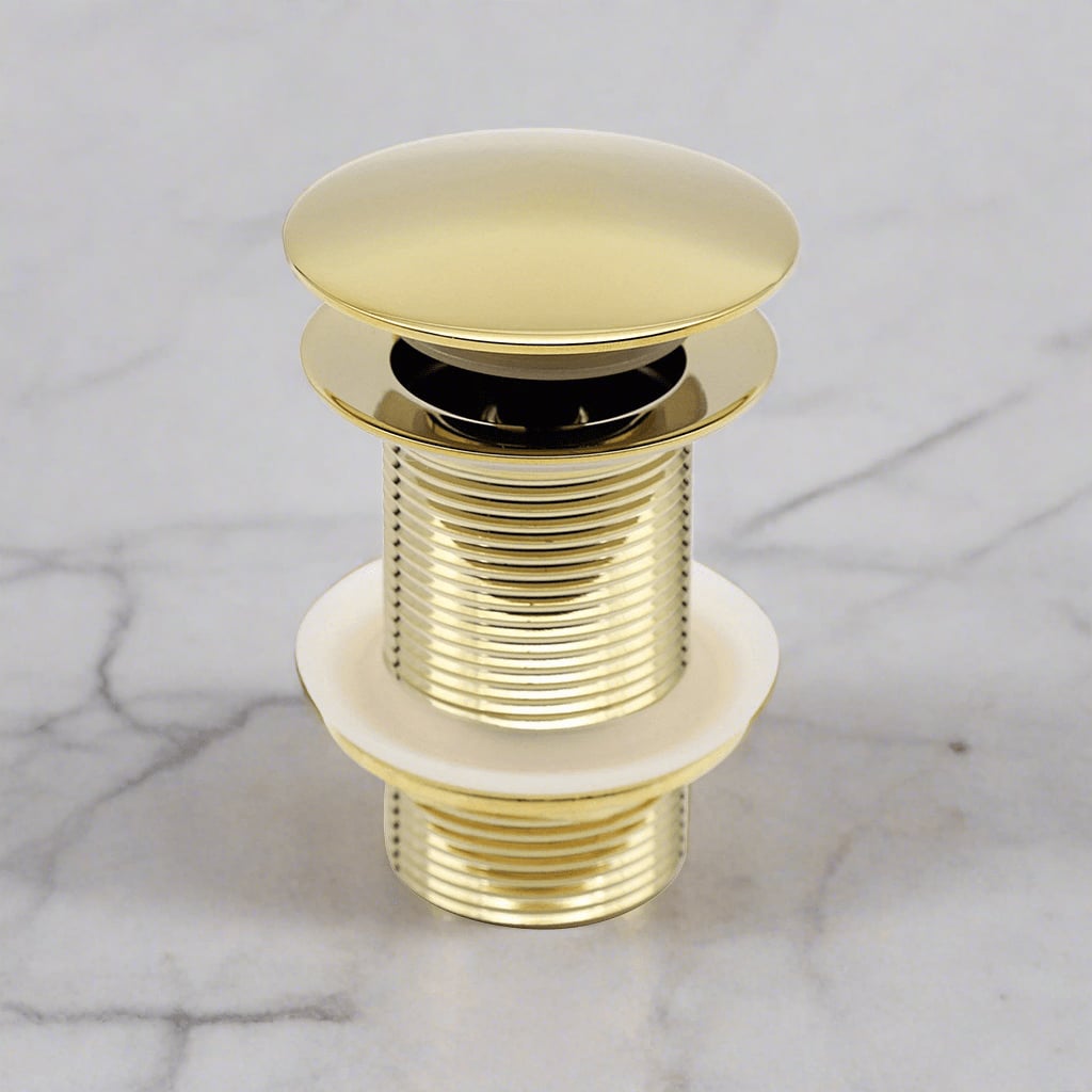 Polished Brass Pop-Up Drain Stopper for Bathroom Sink on a white marble