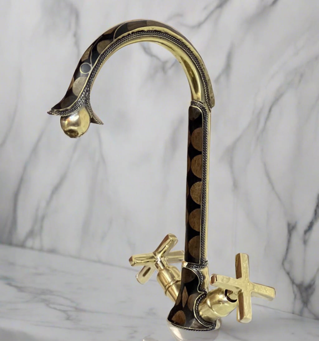 Unlacquered Brass And Resin Bathroom Faucet over a counter-top with white marble background 
