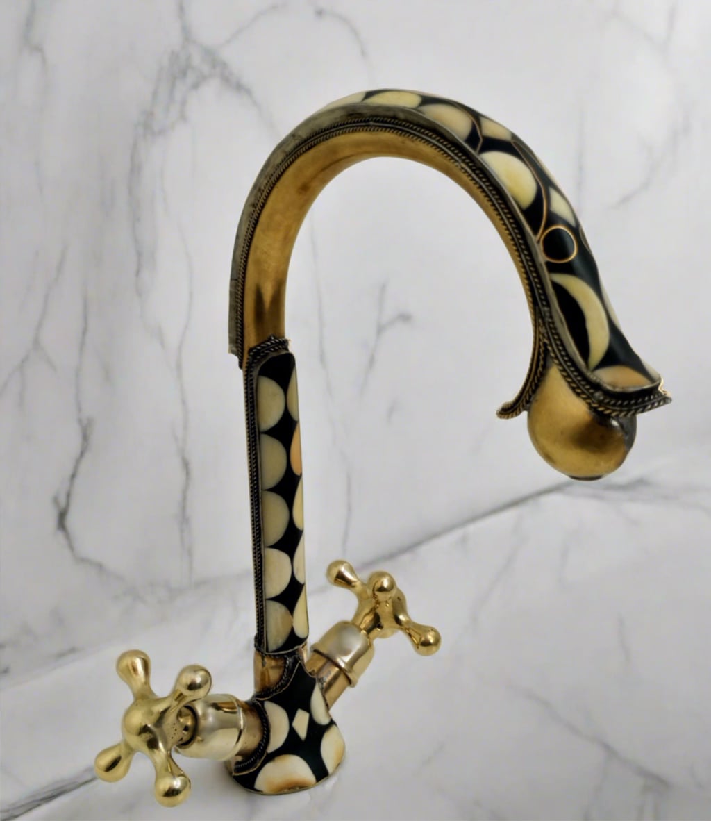 Unlacquered Brass And Resin Bathroom Faucet over a counter-top with white marble background