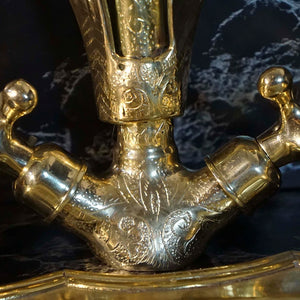 A gold swan shaped gooseneck brass faucet
