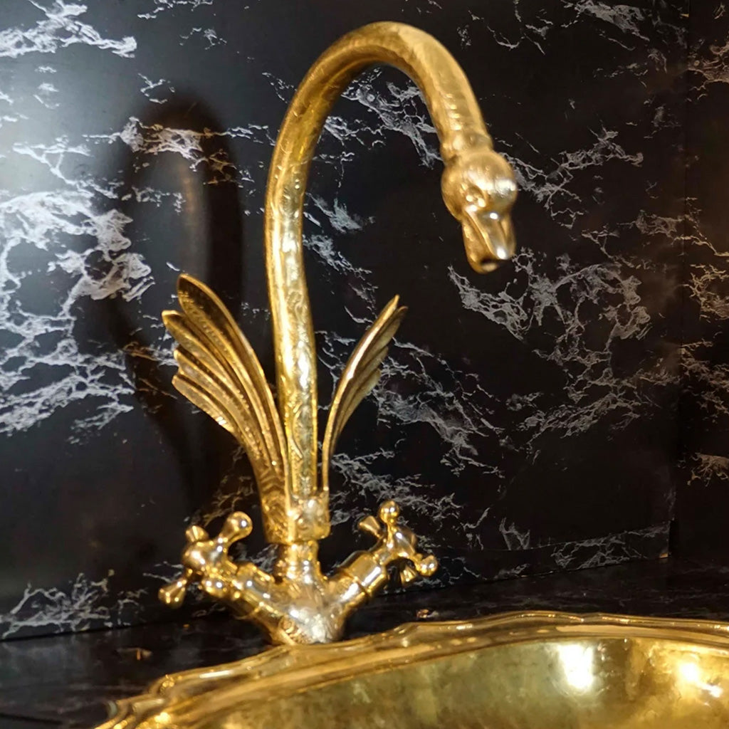 A gold swan shaped gooseneck brass faucet 