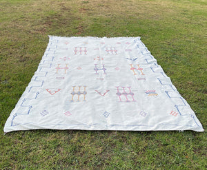 Off white Moroccan sabra rug with Berber motif against grass background - Moroccan Interior