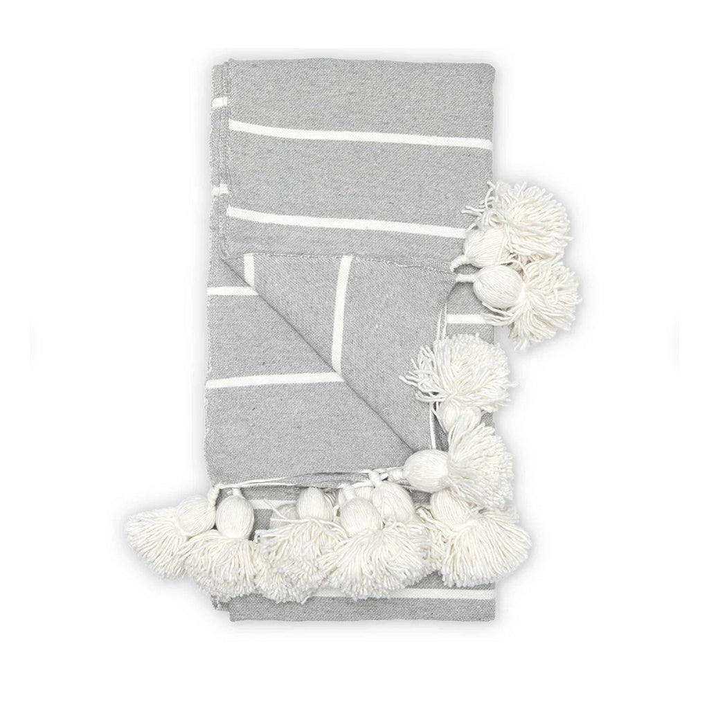 Moroccan Pompom Blanket in light gray against a white background - Moroccan Interior