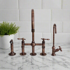 Antique copper bridge kitchen faucet set with side sprayer and separate water filter tap on marble countertop