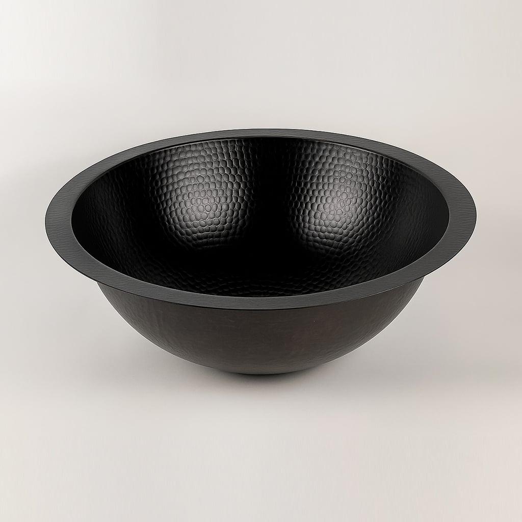 Black hammered copper sink bowl displayed on a white background, showing its textured surface and round shape