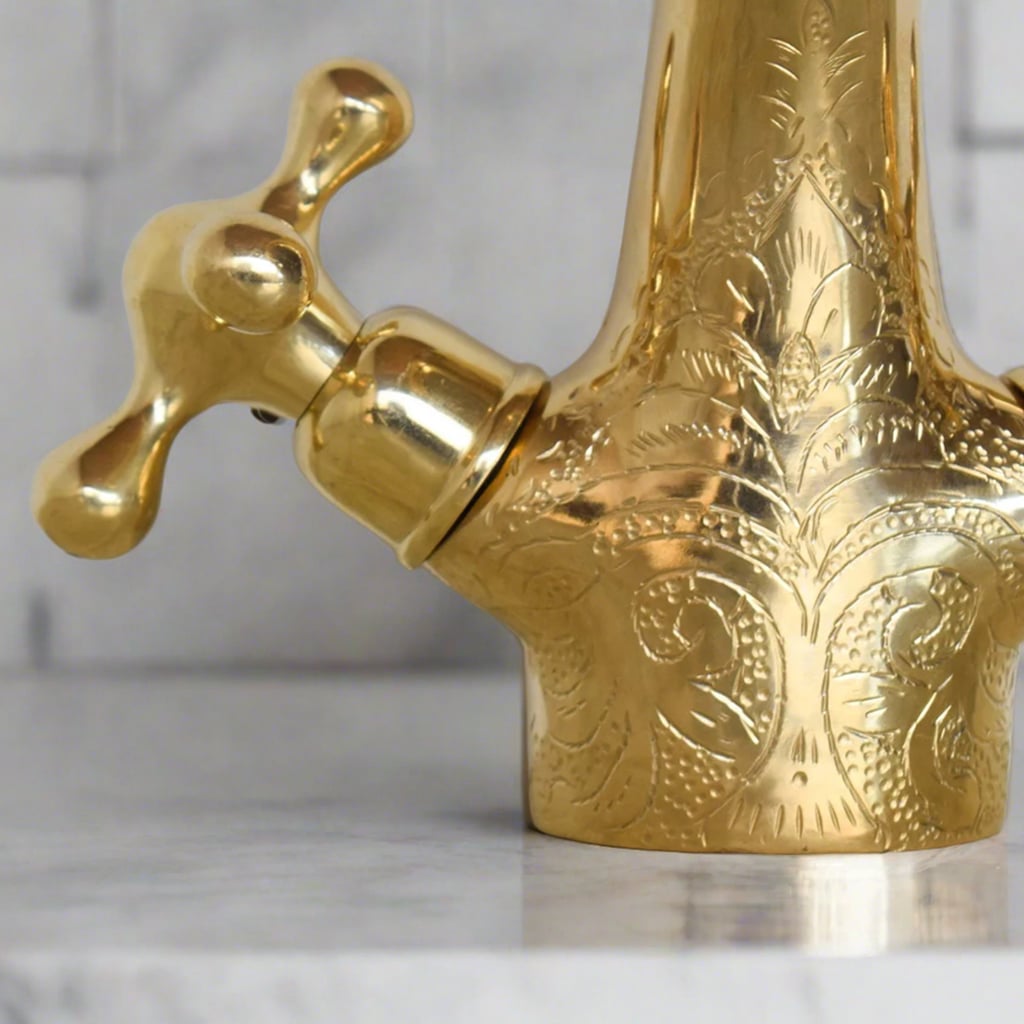 Detailed close-up of the hand-engraved brass handle on the vanity faucet, emphasizing the intricate Moroccan design and artisanal quality