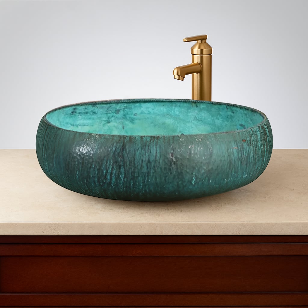 Hand-hammered turquoise patina copper vessel sink with a round shape, paired with a modern brushed gold faucet, mounted on a beige countertop with wood cabinetry