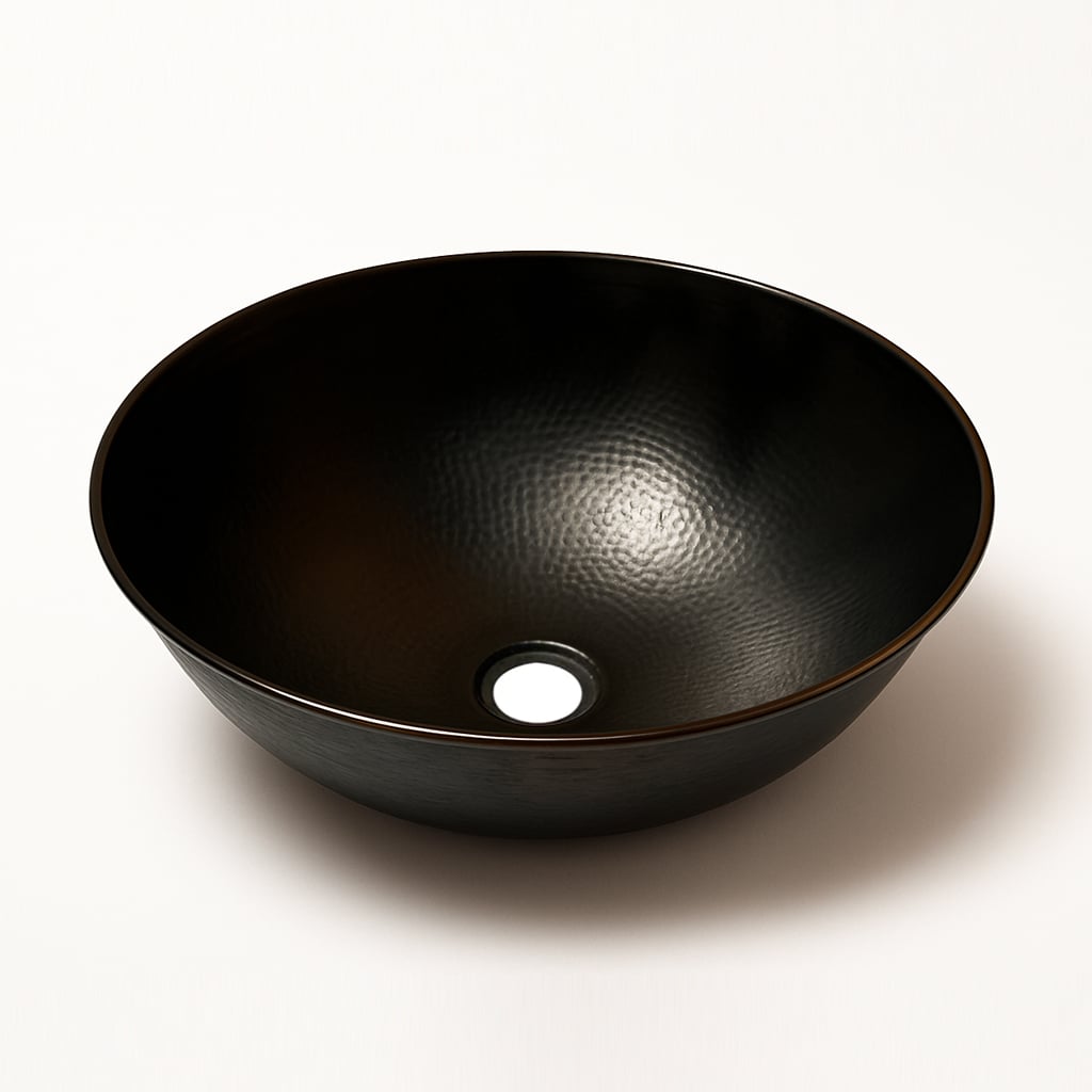Black hammered copper vessel sink with a round shape and center drain hole, shown on a white background