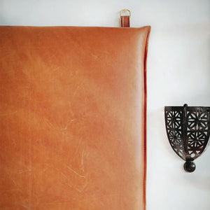 Top corner: Leather headboard on white wall with black metal decoration - Moroccan Interior