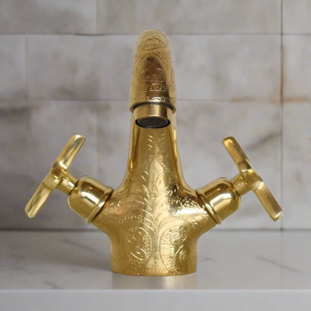 Close-up of the brass faucet's handle and spout, highlighting the detailed hand-engraved Moroccan patterns and craftsmanship