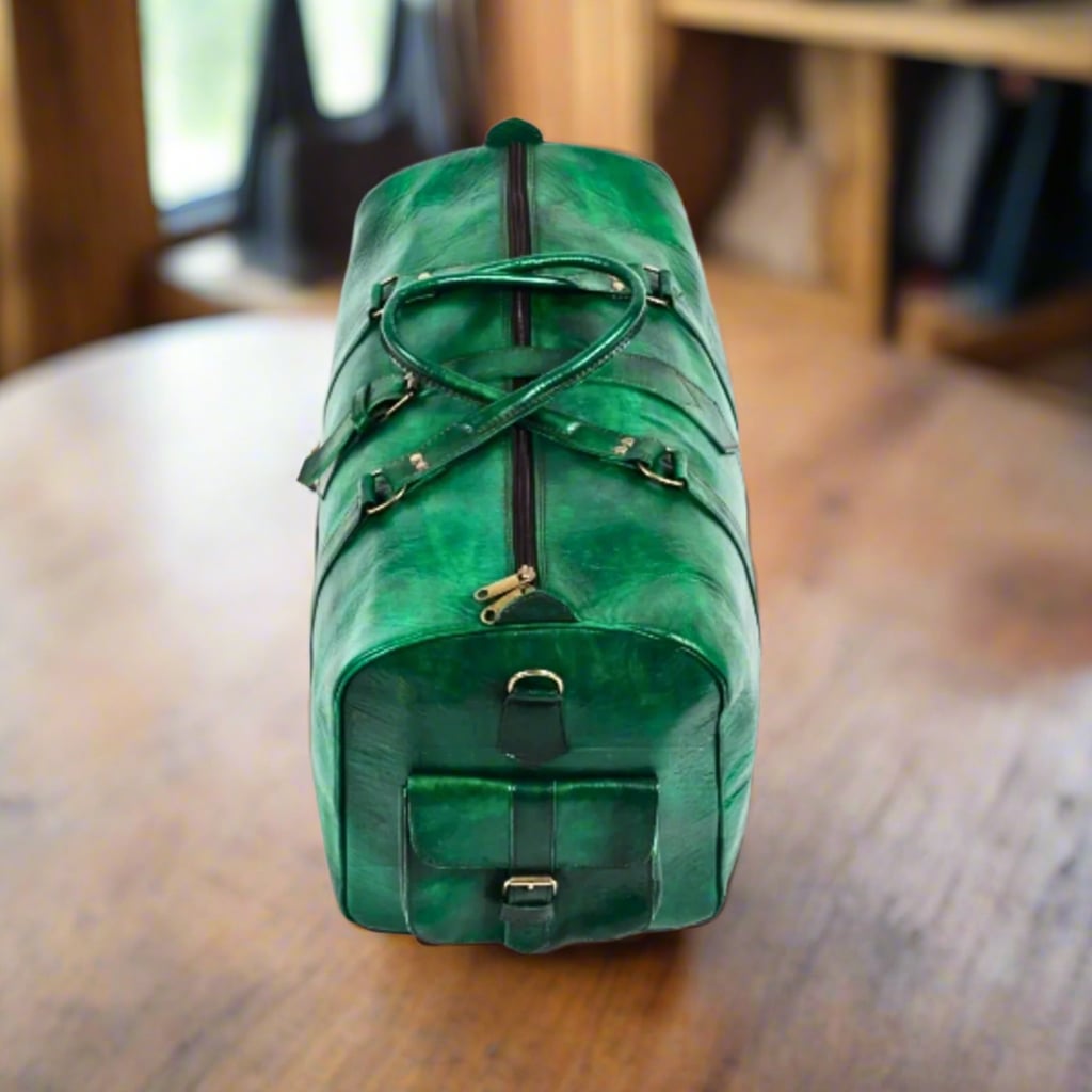 A top and side view of a handcrafted travel bag made entirely from vibrant green leather, showcasing its sturdy handles, adjustable strap, and zippered main compartment