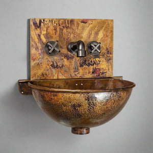 Wall-hung hammered copper sink with a golden-brown patina finish, featuring a rounded bowl and matching copper backplate with cross-handle taps