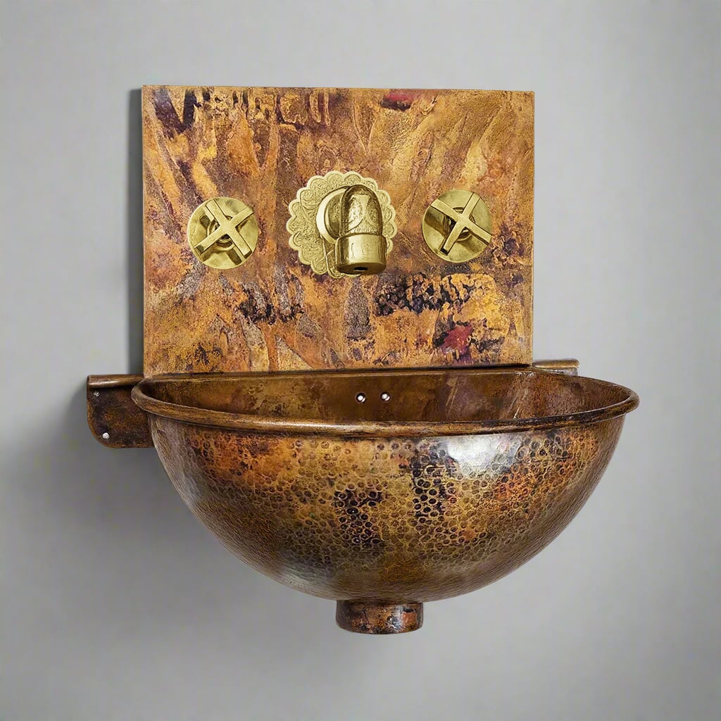 Wall-mounted hammered copper sink with rustic patina finish and golden brass faucet set, designed for space-saving bathrooms and timeless style