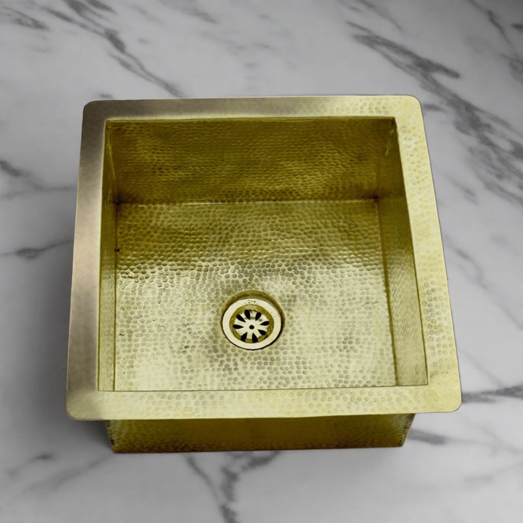 Handcrafted brass kitchen sink with a hammered finish, emphasizing the textured surface and artisanal craftsmanship from Morocco