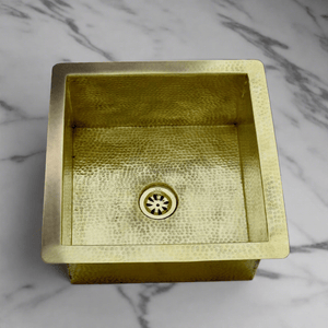 Handcrafted brass kitchen sink with a hammered finish, emphasizing the textured surface and artisanal craftsmanship from Morocco