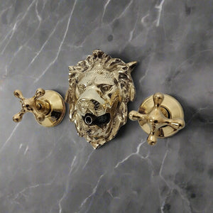 Brass lion head wall-mounted faucet with two cross handles on a dark marble surface