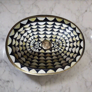 Oval Undermount Brass Sink decorated with handmade pattern over a counter top with white marbel - Moroccan Interior
