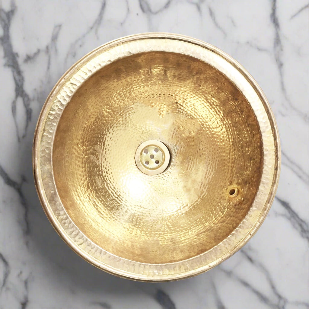Moroccan brass drop-in sink hand-hammered, on a white marble - Moroccan Interior