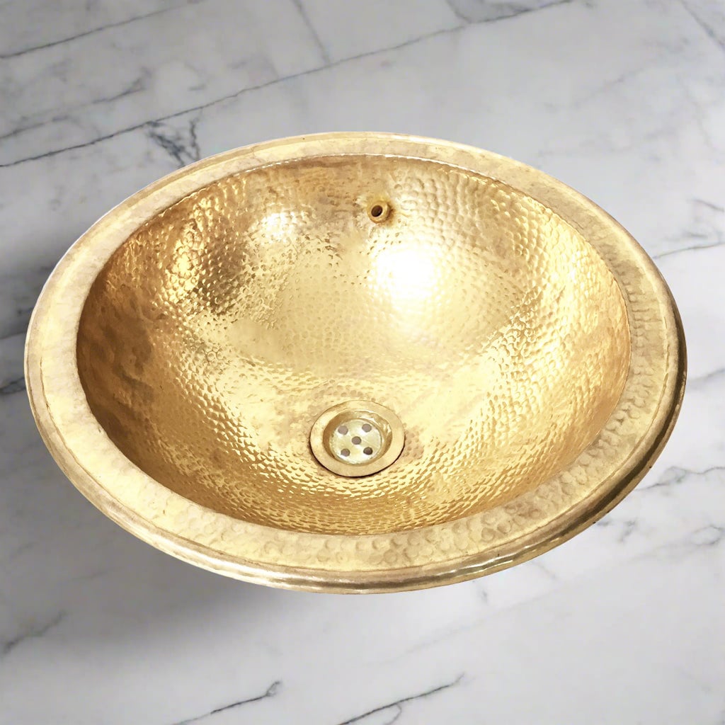 Moroccan brass drop-in sink hand-hammered, on a white marble - Moroccan Interior