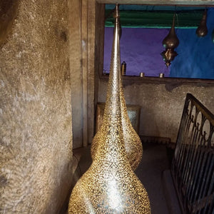 Pair of Moroccan brass floor lamps near the old stairs of a house in Marrakesh - Moroccan interior.