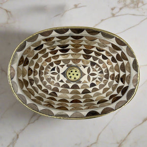 Oval Undermount Brass Sink decorated with handmade pattern over a counter top with white marbel - Moroccan Interior