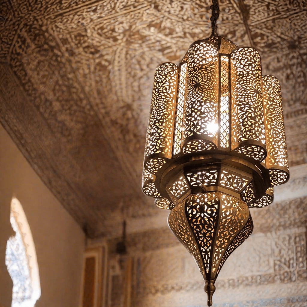 Handcrafted Moroccan brass ceiling fixture with intricate geometric patterns, casting warm light and shadows on a traditional room's ceiling