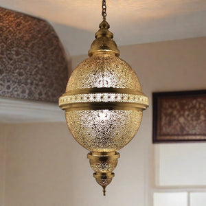 Handcrafted Moroccan ceiling lamp made of brass, hanging in a warmly lit room, showcasing intricate patterns and detailed craftsmanship