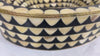 Close-up- video presentation of an oval decorative bathroom sink with intricate black and bone inlay pattern on marble countertop