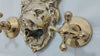 brass lion head wall-mounted faucet set with two cross handles on marble background, shown in close-up  video thumbnail view