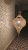 A video of a Brass pendant light hanging from the ceiling in an old home in Marrakesh - Moroccan Interior