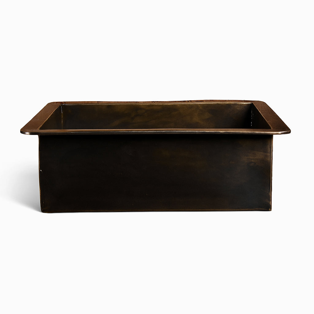 Front view of a rectangular brass sink with a dark antique finish and wide rim edges