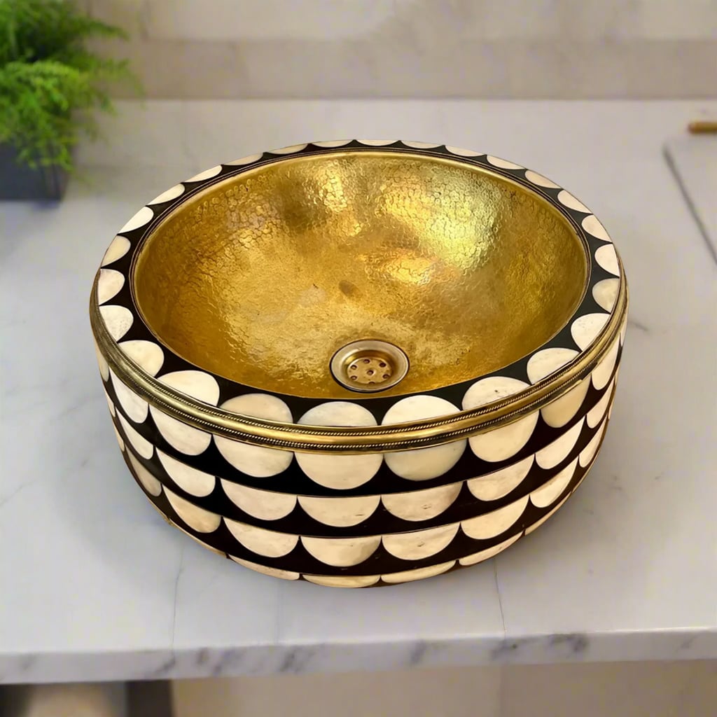 Top view of a round brass bathroom sink with dazzling mother-of-pearl inlay exterior, showcasing a hammered gold interior finish