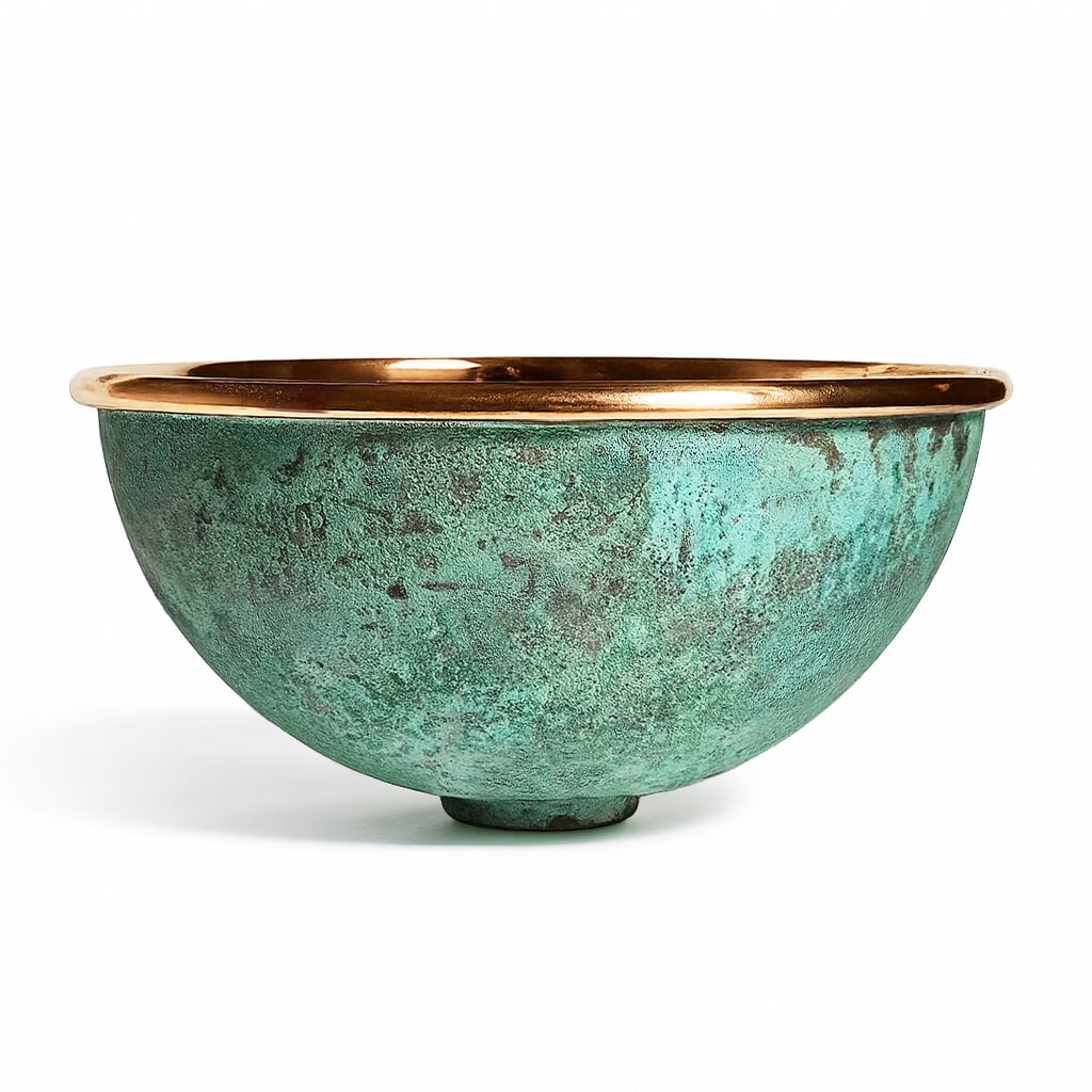 Handcrafted round copper basin with a polished rim and verdigris green patina exterior, combining rustic character with artisanal elegance