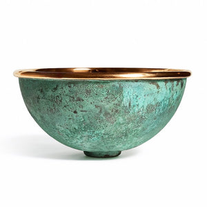 Handcrafted round copper basin with a polished rim and verdigris green patina exterior, combining rustic character with artisanal elegance