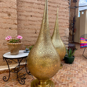 Set of two Moroccan brass floor lamps on a balcony in an old house in Marrakesh - Moroccan interior.