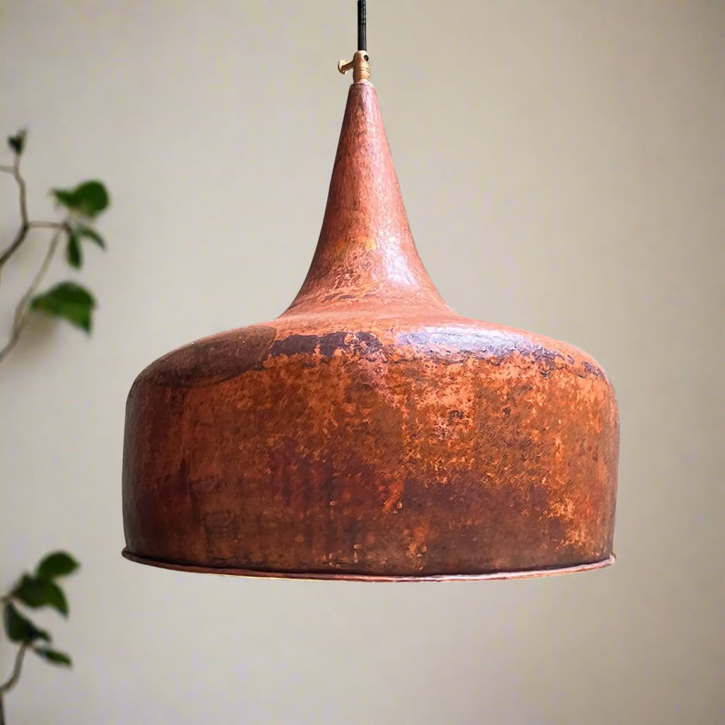 Handcrafted tapered copper pendant light with an aged patina finish, featuring a unique bell silhouette and suspended cord
