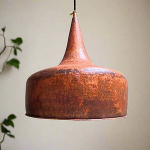 Handcrafted tapered copper pendant light with an aged patina finish, featuring a unique bell silhouette and suspended cord