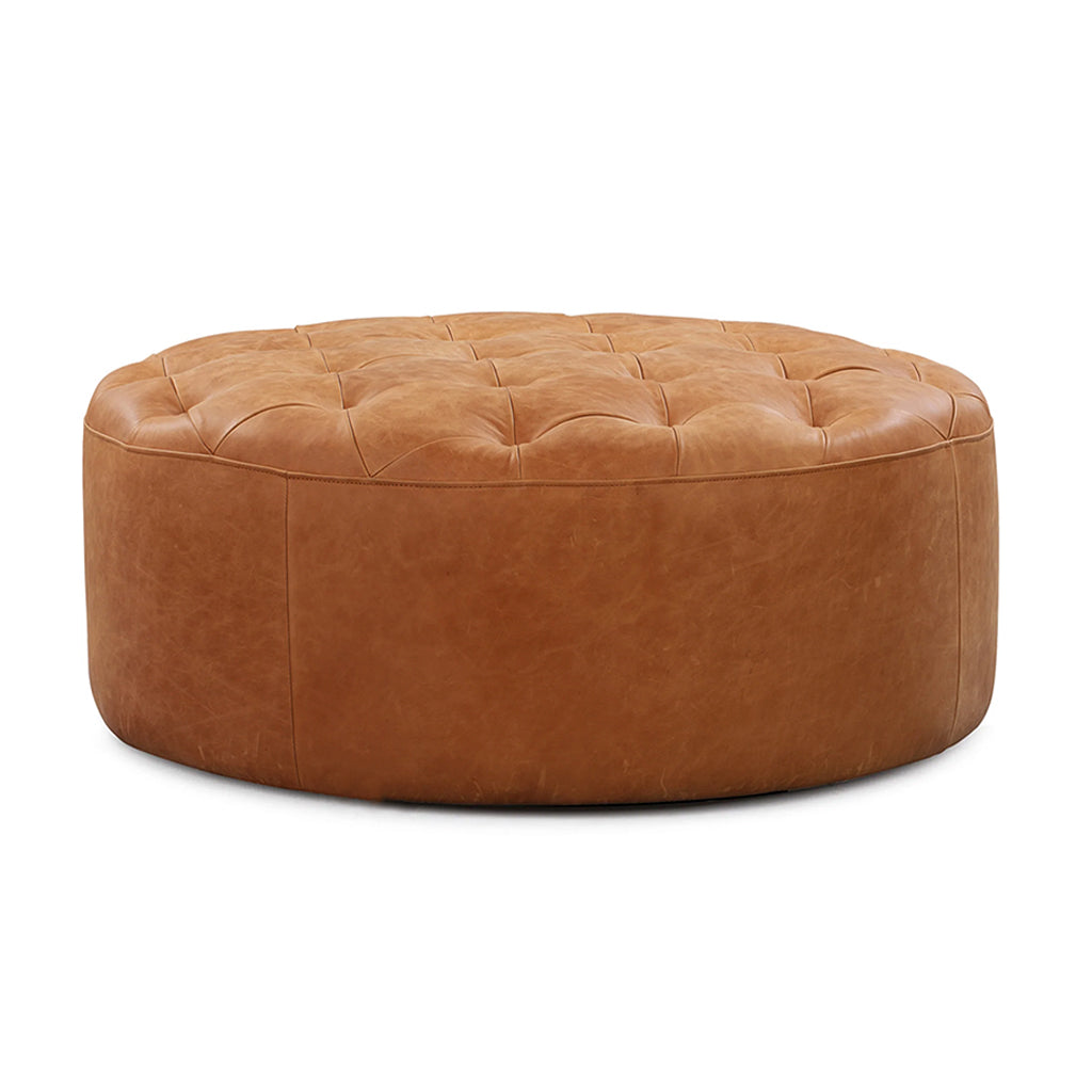 Front view of a tufted round leather pouf in tan color on a white background - Moroccan Interior.