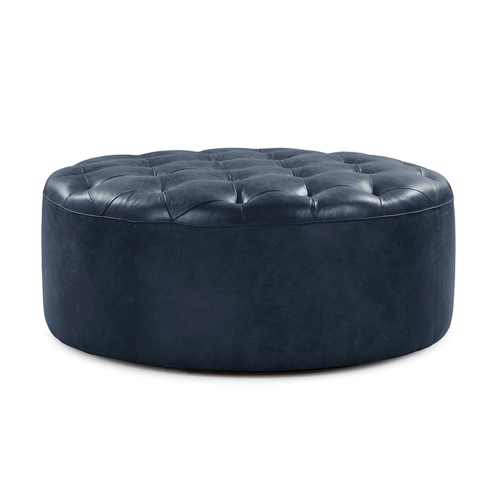 Front view of a tufted round leather pouf in dark blue color on a white background - Moroccan Interior.