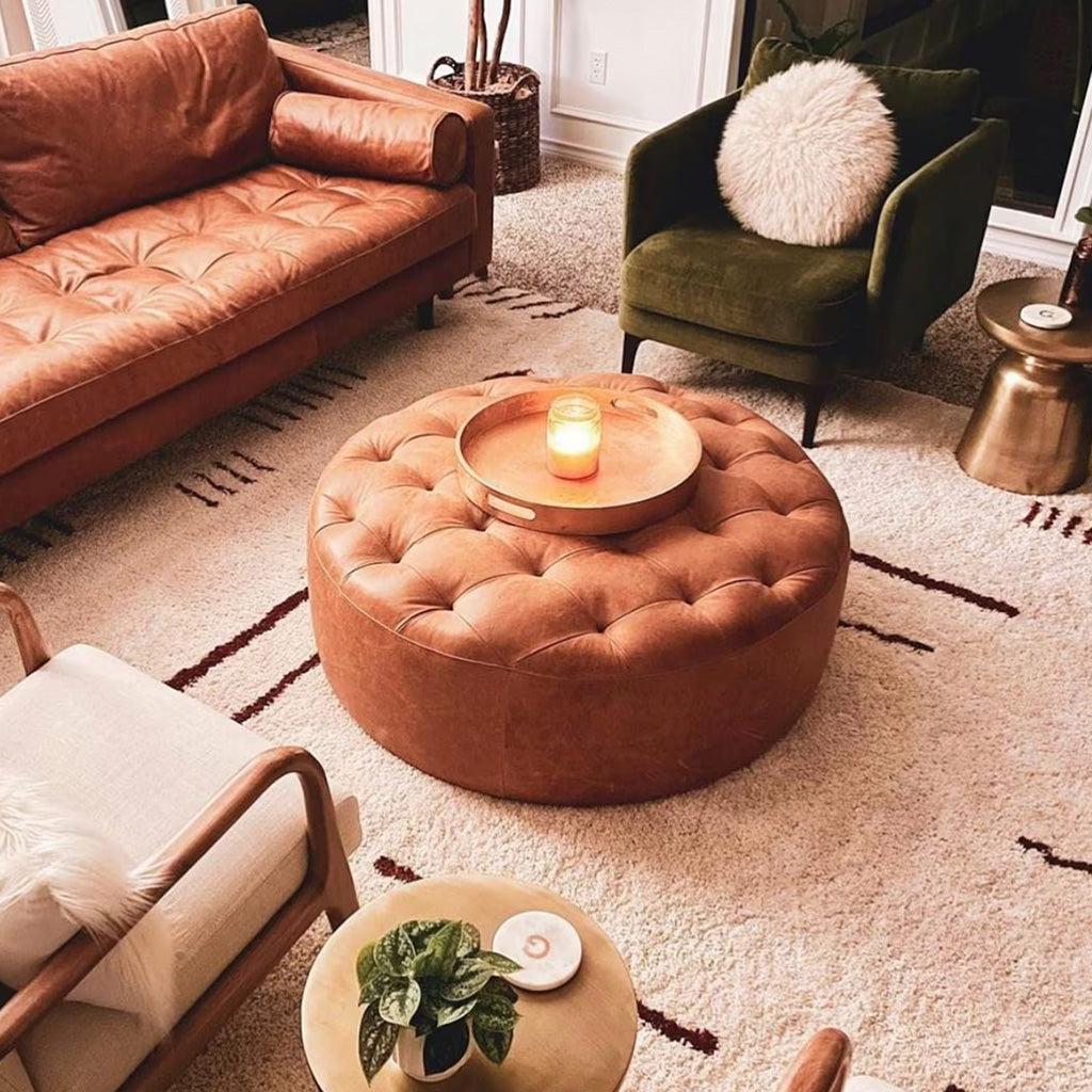 Scandinavian living room with Moroccan wool rug, 3-seat leather sofas, armchairs, tufted leather pouf with tray - Moroccan Interior