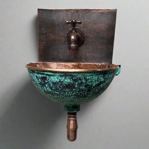 Wall-mounted verdigris copper sink with hammered finish and rustic bronze faucet, perfect for vintage-inspired and artisanal bathroom interiors