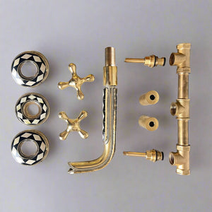 Complete wall-mount faucet parts set including inlay spout, cross handles, escutcheons, and internal brass valve components