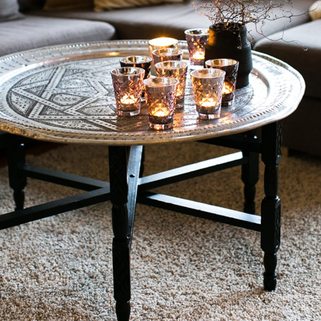 Gray sofas and a Moroccan tea table with glass candles and a tree vase in a minimalist living room - Moroccan Interior