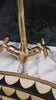 Video showing a gold brass faucet with double tap mixer in contemporary modern bathroom with stone marble stoneware countertop - Moroccan Interior