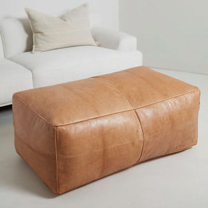 Moroccan Leather Bench beside a white sofas with pillows in a living space - Moroccan Interior